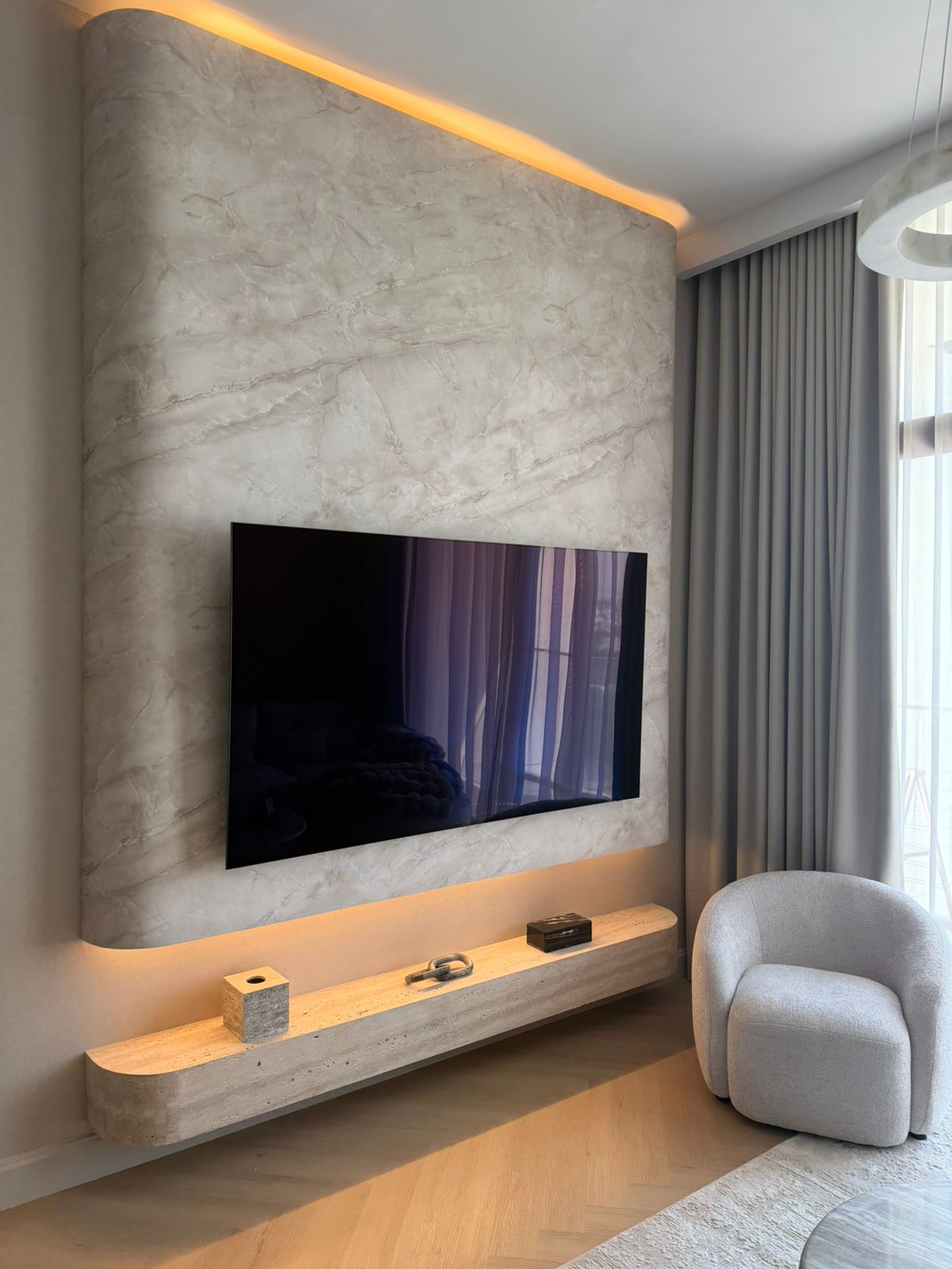 Curved look a like marble media wall with floating travertine natural stone TV unit